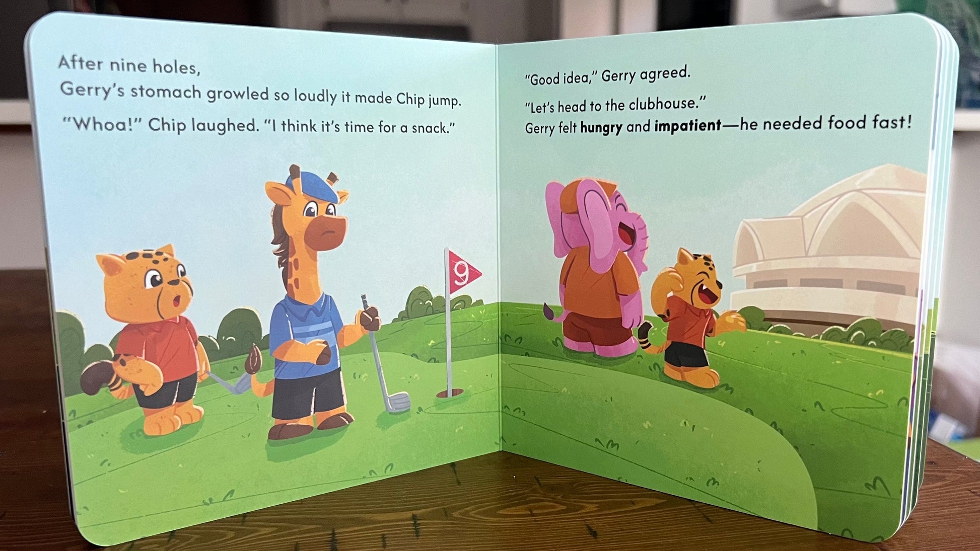 Open children's book with cartoon characters on a wooden surface