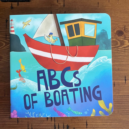 Children's book titled 'ABCs of Boating' on a wooden surface
